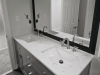 A grey bathroom with white countertops