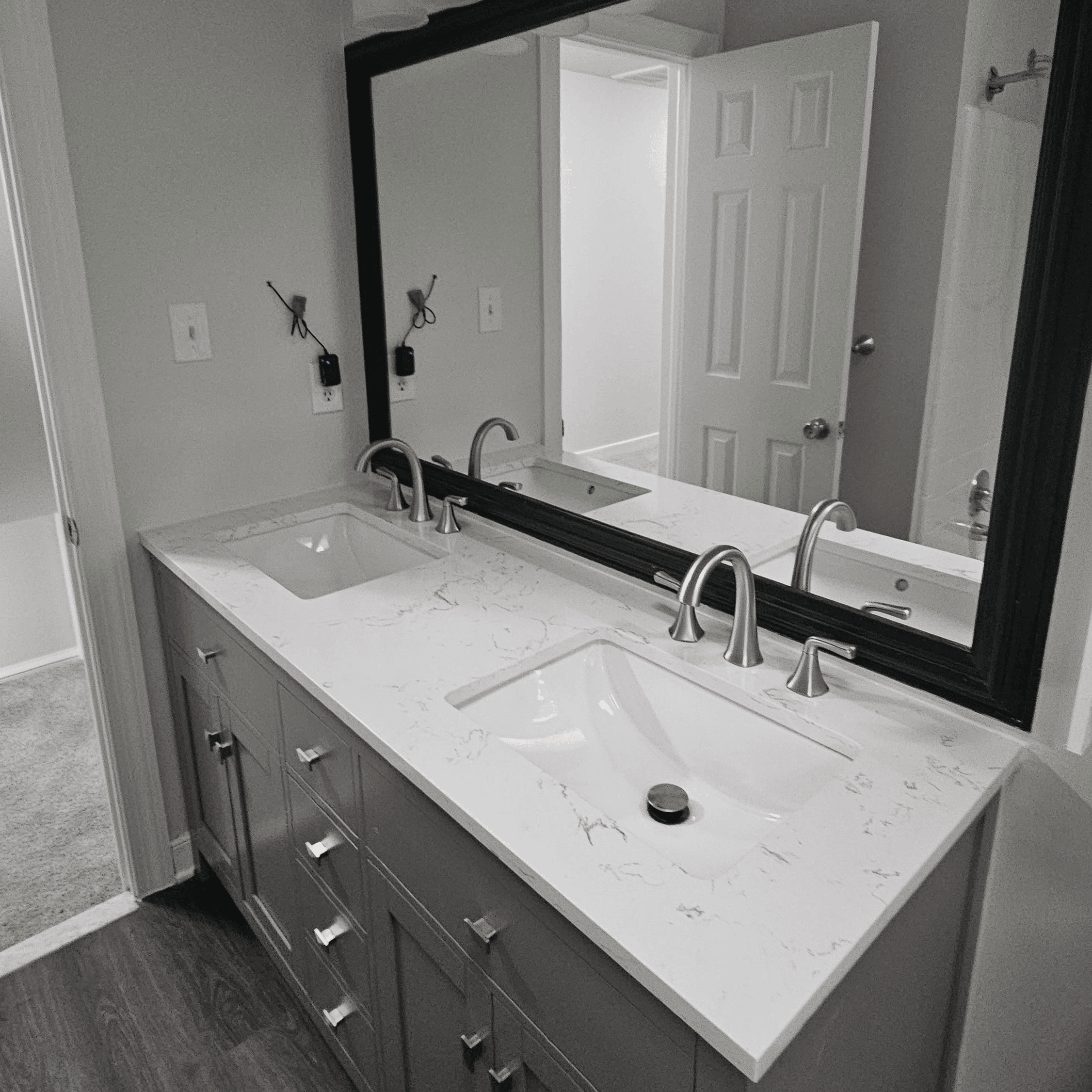 A grey bathroom with white countertops